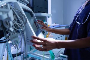 healthcare professional operating a medical device