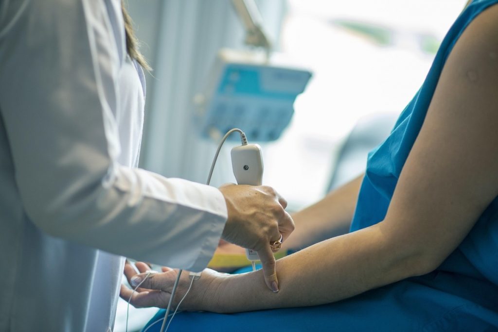 medical worker with patient - featured image